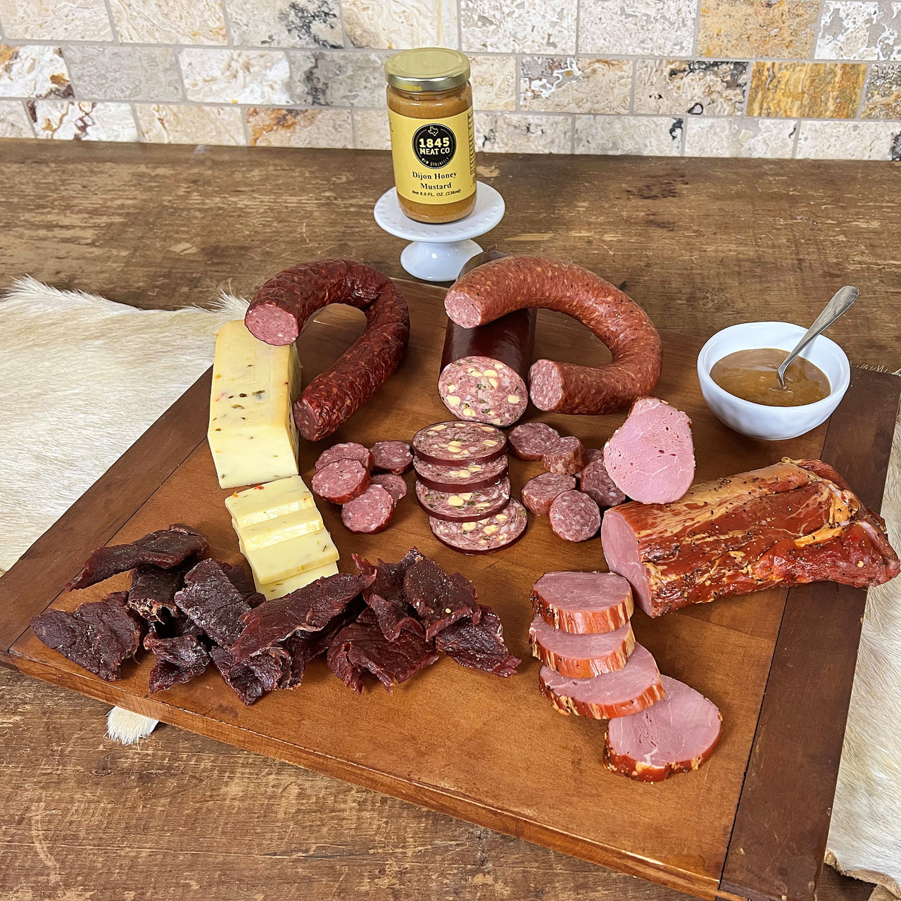 A great collection of items for when friends come over for the evening.  Includes:  16 oz. of Pork Tenderloin 8 oz. Dietert Family Pork & Beef Ring Sausage 8 oz. Tays Family Venison & Pork Ring Sausage 12 oz. of Cheddar Jalapeno Summer Sausage 8 oz. Smoked Pepper Jack Cheese 3 oz. of BBQ Seasoned Beef Jerky  8 oz. Jar of Honey Dijon Mustard ﻿Item #15E
