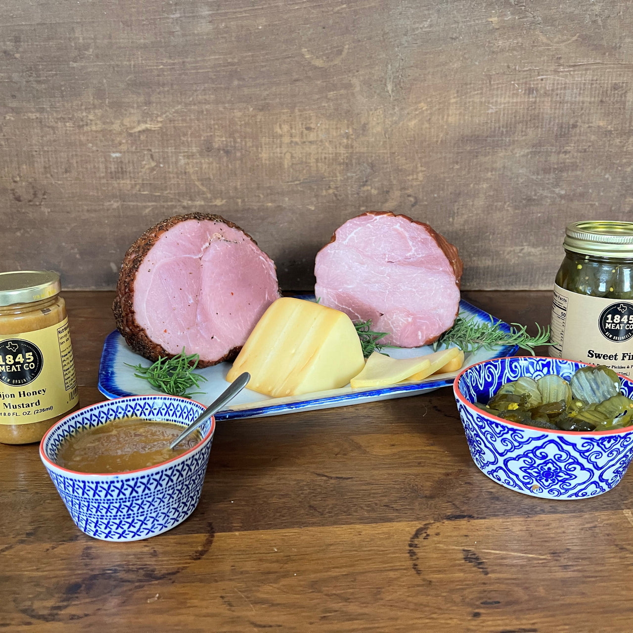 A great assortment of our Boneless Hams that will make your mouth water.  Includes:  2 - 3 lbs. Boneless Ham 2 - 3 lbs. Peppered Boneless Ham 8 oz. Smoked Baby Swiss Cheese 8 oz. Jar of Honey Dijon Mustard 16 oz. Jar of Sweet Fire Pickles ﻿Item #55E