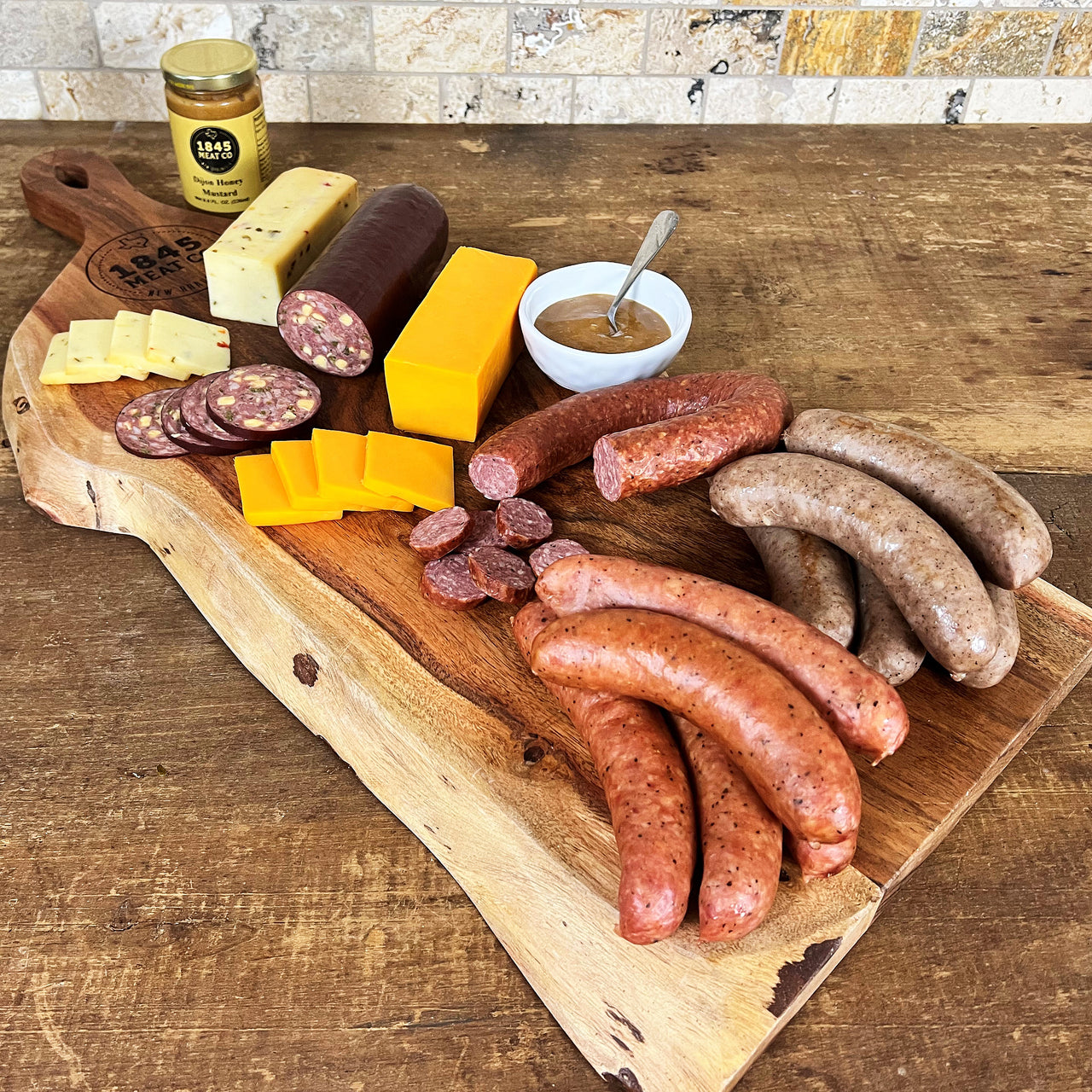 This assortment is a collection of some of our favorites.  Includes:  16 oz. of Pork & Beef Sausage 16 oz. of Bratwurst 12 oz. Cheddar Jalapeno Summer Sausage 8 oz. Dietert Family Pork & Beef Ring Sausage 8 oz. Smoked Cheddar Cheese 8 oz. Smoked Pepper Jack Cheese 8 oz. Jar of Honey Dijon Mustard ﻿Item #10E